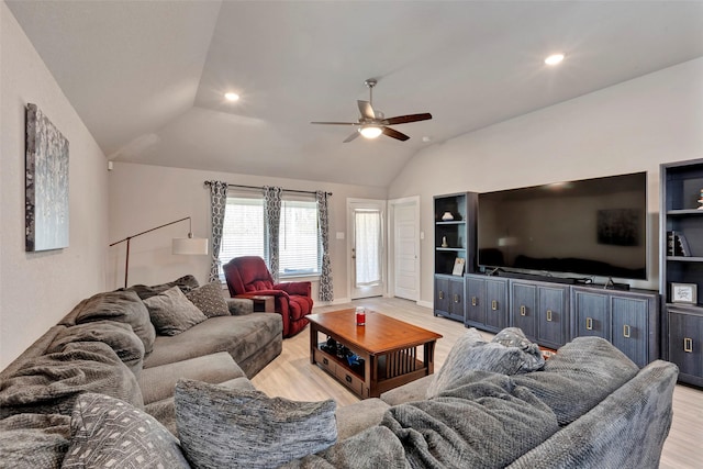 living room featuring lofted ceiling, light hardwood / wood-style floors, and ceiling fan