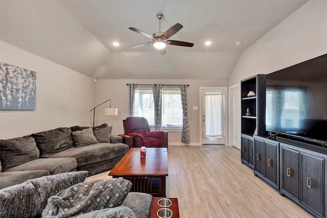 living room featuring lofted ceiling, ceiling fan, and light hardwood / wood-style flooring