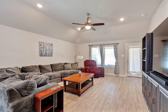 living room featuring ceiling fan, vaulted ceiling, and light wood-type flooring