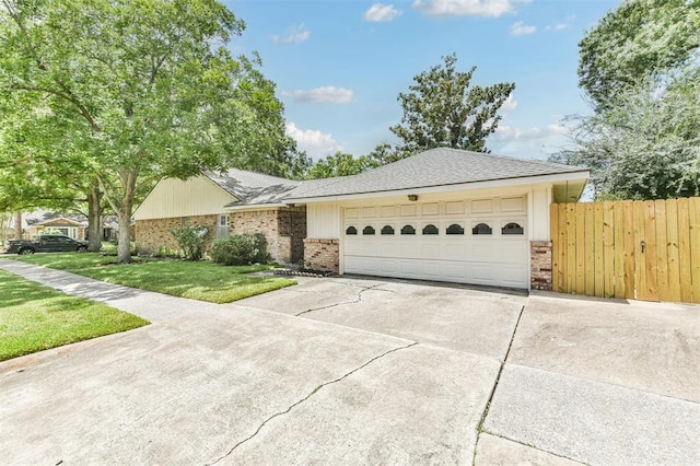 ranch-style home with a garage and a front yard