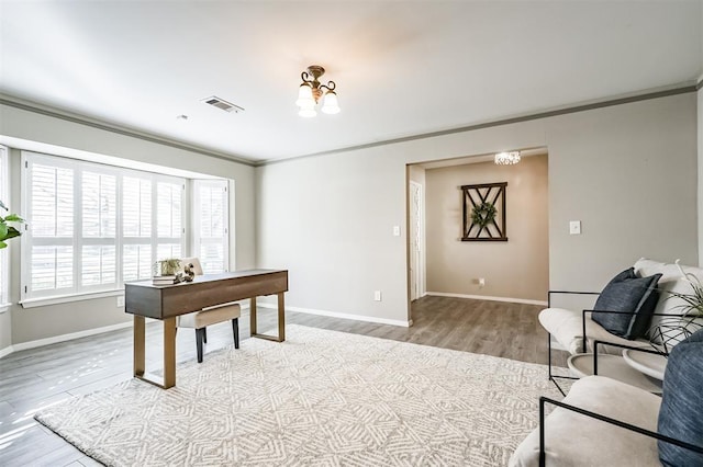 office area with ornamental molding and light hardwood / wood-style floors