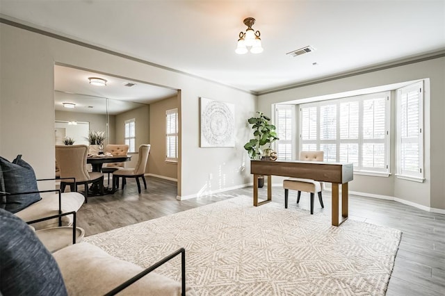 home office with crown molding and hardwood / wood-style flooring