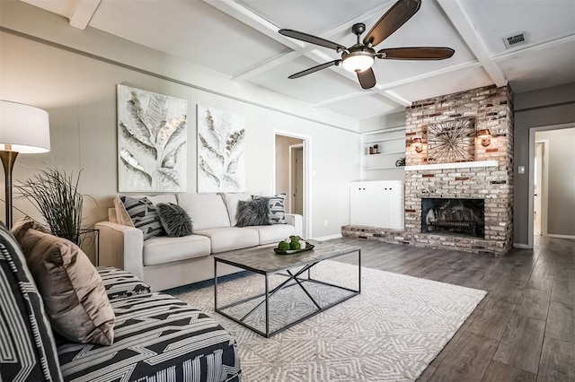 living room featuring built in features, a fireplace, hardwood / wood-style flooring, coffered ceiling, and beam ceiling