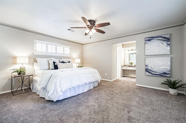 bedroom featuring crown molding, ensuite bathroom, and carpet