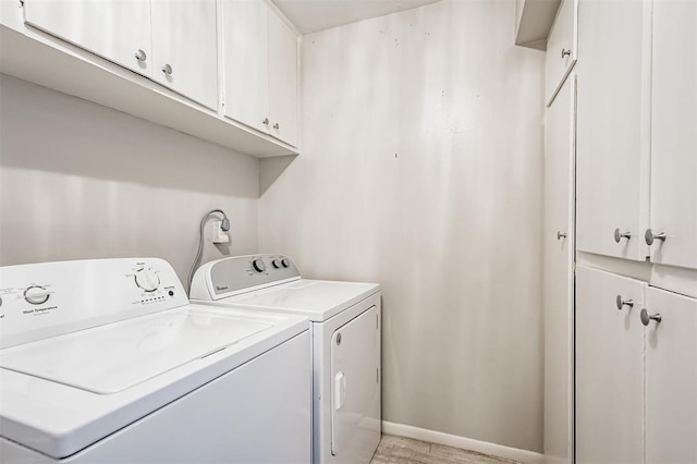 laundry room with cabinets and washing machine and dryer