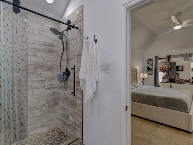 bathroom with vaulted ceiling, tiled shower, tile patterned floors, and ceiling fan