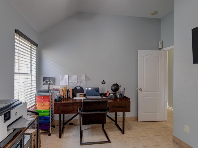 office space with lofted ceiling and light tile patterned floors