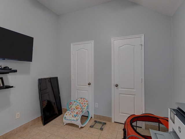 game room with light tile patterned flooring and lofted ceiling