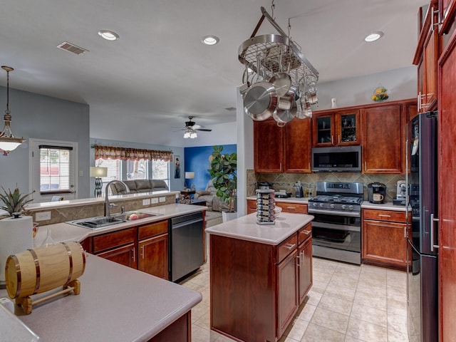 kitchen featuring sink, tasteful backsplash, a center island, pendant lighting, and stainless steel appliances