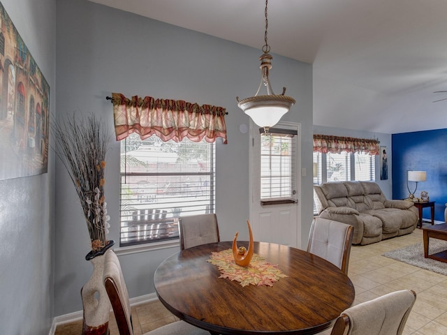 dining room featuring lofted ceiling and light tile patterned floors