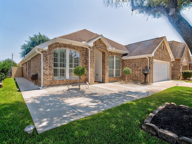 ranch-style home with a garage and a front lawn