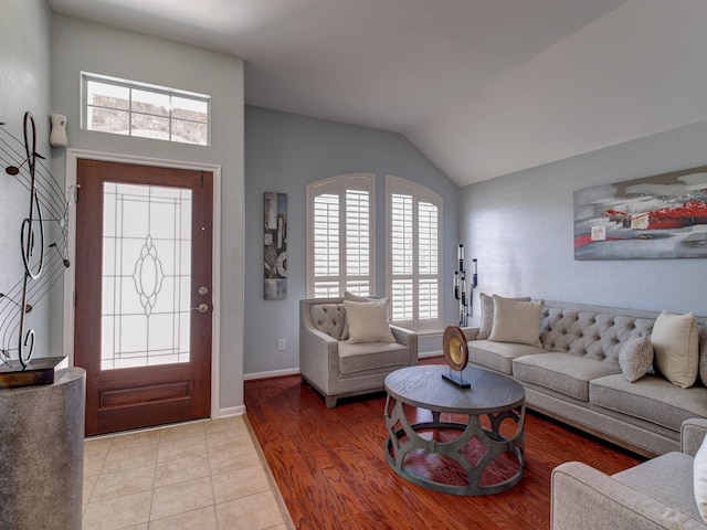 living room with lofted ceiling and light tile patterned floors