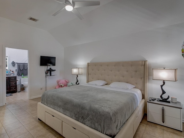 tiled bedroom featuring ceiling fan, ensuite bath, and lofted ceiling