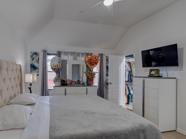 bedroom with lofted ceiling, a spacious closet, ceiling fan, and a closet