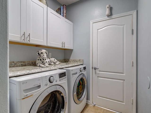 laundry room with separate washer and dryer, light tile patterned floors, and cabinets