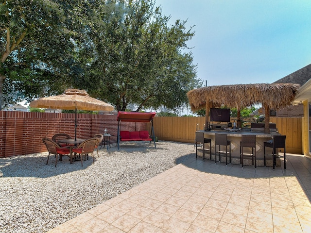 view of patio / terrace featuring a bar and grilling area