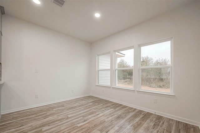 spare room featuring light hardwood / wood-style floors