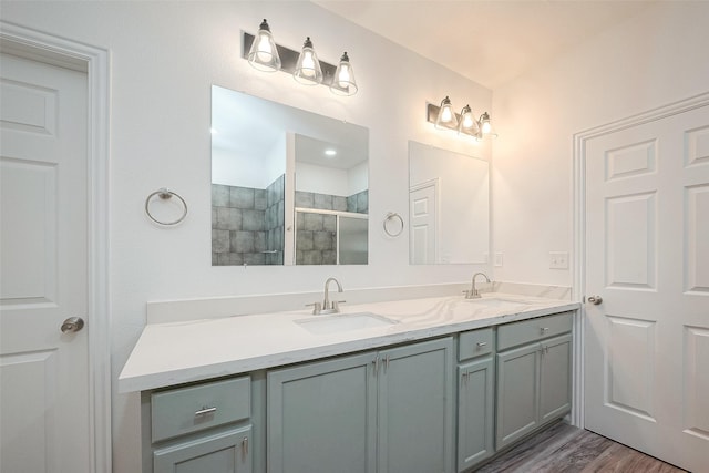 bathroom with vanity, hardwood / wood-style floors, and walk in shower