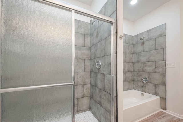 bathroom featuring shower with separate bathtub and hardwood / wood-style floors