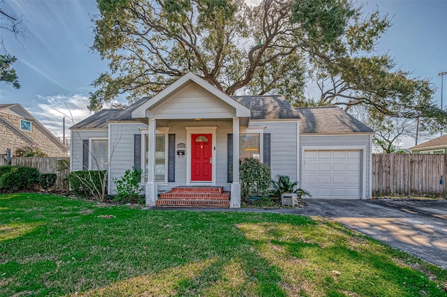 bungalow featuring a garage and a front yard