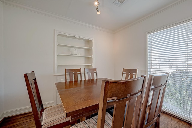 dining space featuring ornamental molding and dark hardwood / wood-style floors