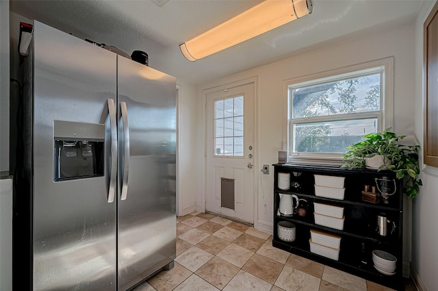 kitchen featuring stainless steel refrigerator with ice dispenser