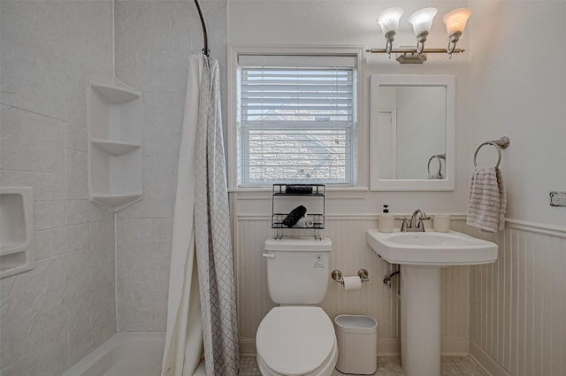 full bathroom with shower / bath combination with curtain, toilet, and sink