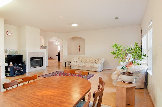 dining area with a fireplace and light wood-type flooring