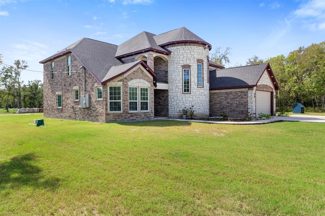 view of front of home with a garage and a front lawn