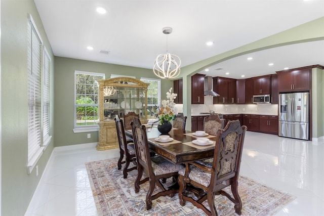 dining room with an inviting chandelier and light tile patterned floors