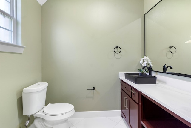 bathroom featuring vanity, tile patterned floors, and toilet