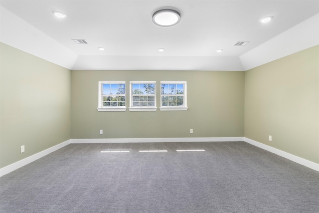 spare room with lofted ceiling and carpet flooring