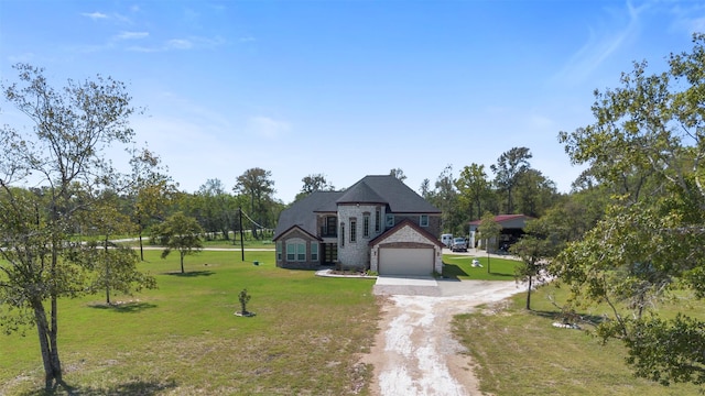 french country style house featuring a garage and a front lawn