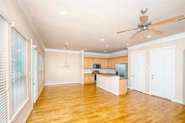 kitchen featuring pendant lighting, a kitchen island with sink, stainless steel appliances, ornamental molding, and light wood-type flooring