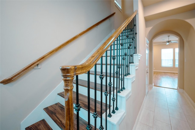 stairway with tile patterned flooring and ceiling fan