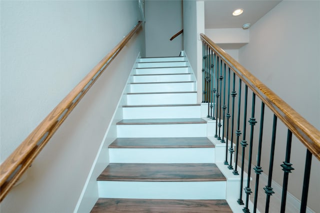 stairs with hardwood / wood-style floors