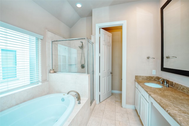 bathroom featuring vaulted ceiling, vanity, independent shower and bath, and tile patterned flooring