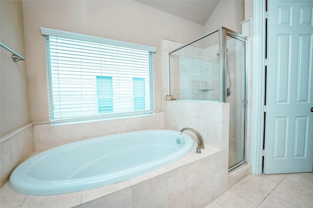 bathroom featuring tile patterned flooring and shower with separate bathtub