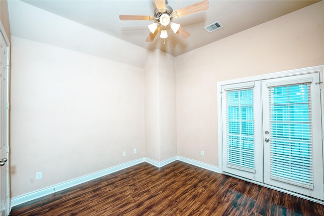 empty room with ceiling fan and dark hardwood / wood-style flooring