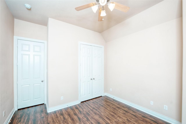 unfurnished bedroom featuring ceiling fan, lofted ceiling, dark hardwood / wood-style floors, and a closet