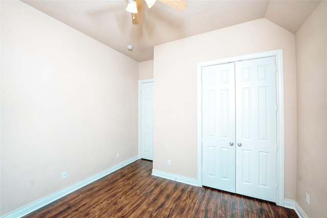 unfurnished bedroom featuring ceiling fan, lofted ceiling, dark hardwood / wood-style flooring, and a closet