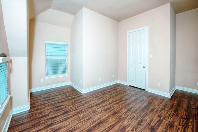 interior space with dark hardwood / wood-style floors and vaulted ceiling