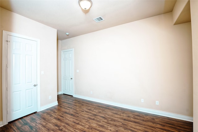 unfurnished room featuring dark hardwood / wood-style floors