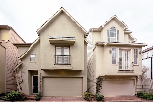 view of front of property featuring a garage and a balcony