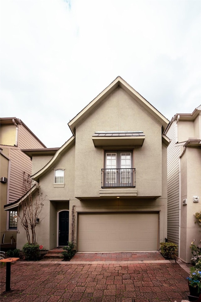 view of front of property with a garage and a balcony