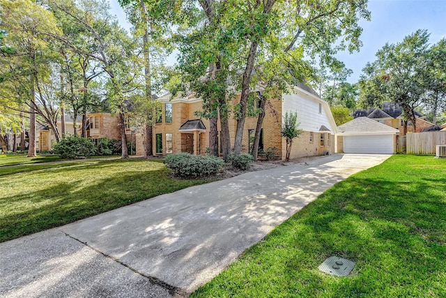 view of front of home with central AC, a garage, and a front lawn