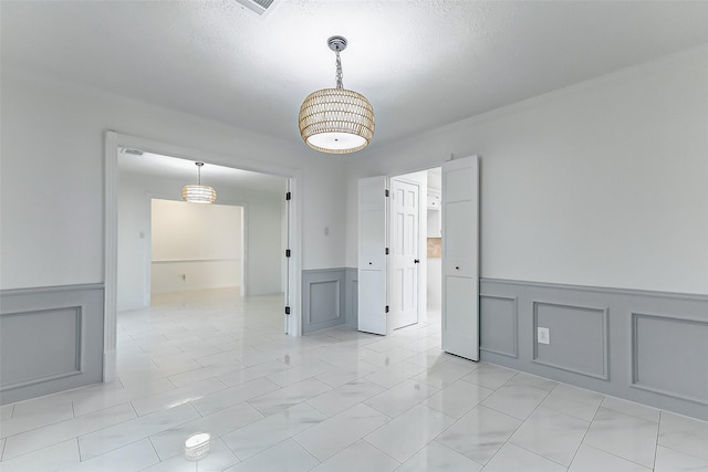 unfurnished room featuring a textured ceiling