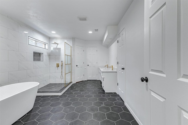 bathroom featuring vanity, independent shower and bath, and tile patterned flooring