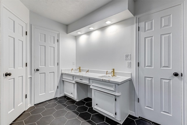 bathroom featuring tile patterned flooring and vanity