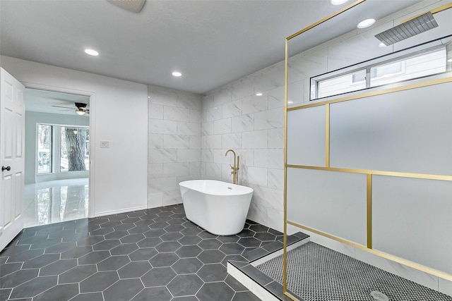 bathroom featuring independent shower and bath, tile walls, tile patterned floors, and ceiling fan